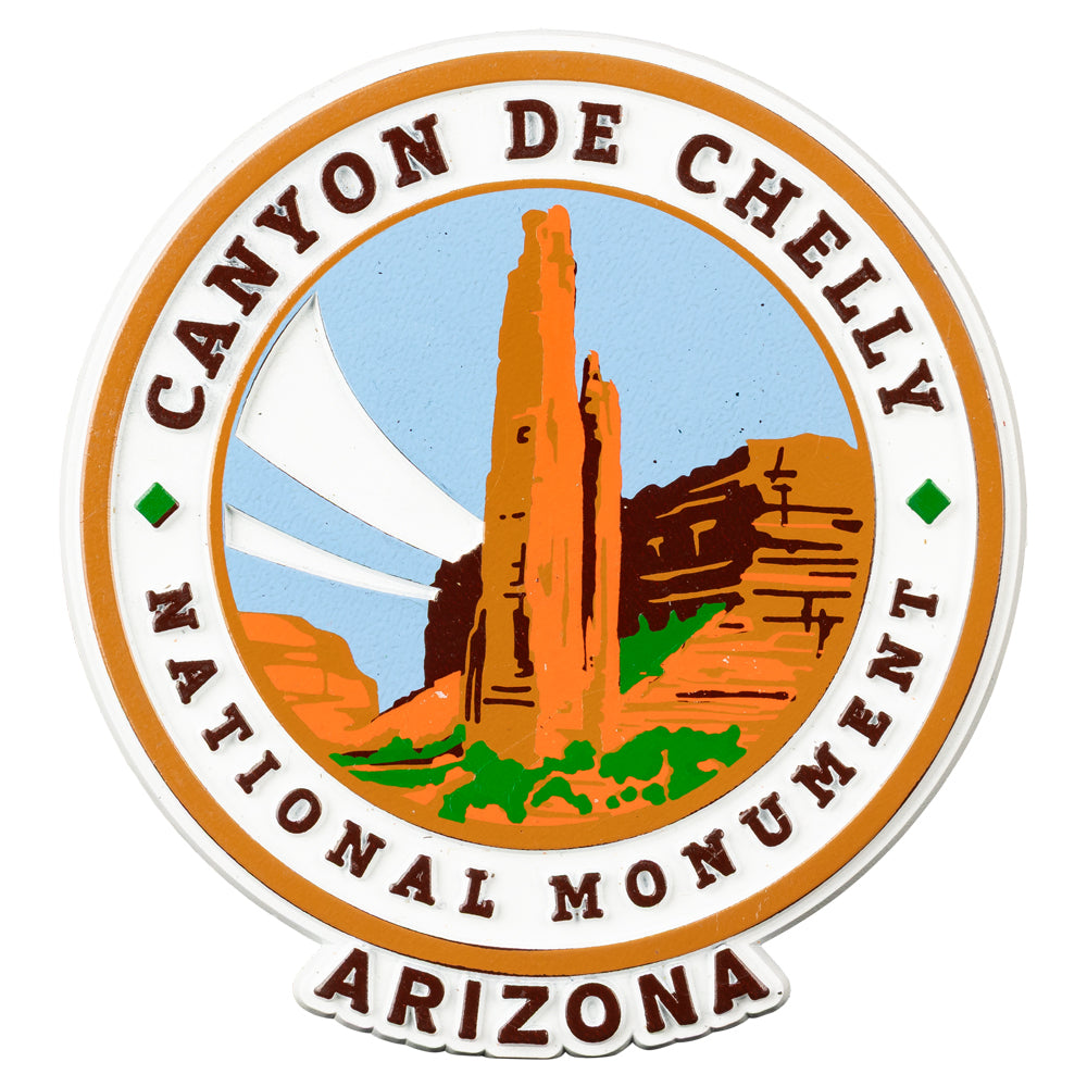 Logo magnet of Canyon de Chelly National Monument in Arizona with desert landscape illustration.