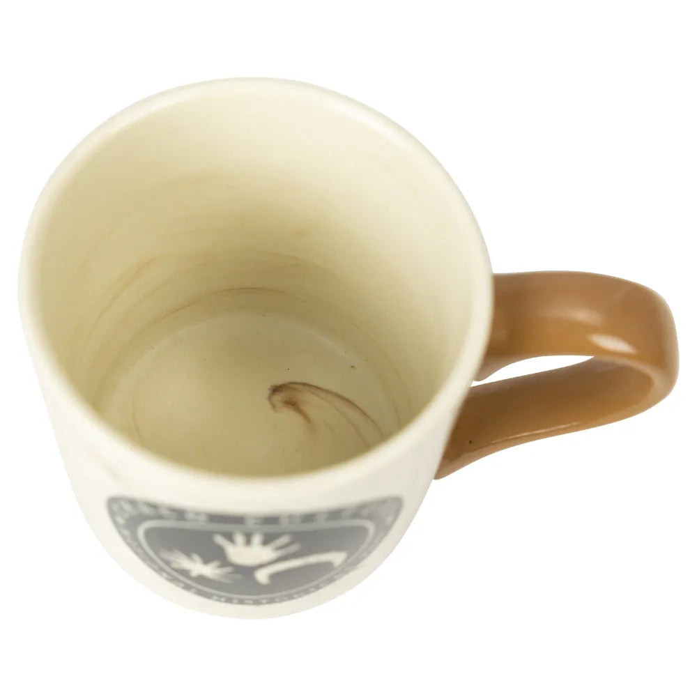 Beige mug with brown handle on a white background