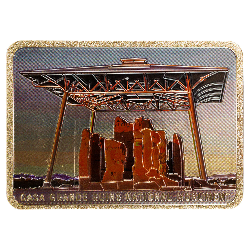 Metallic badge with Casa Grande Ruins National Monument design on a white background