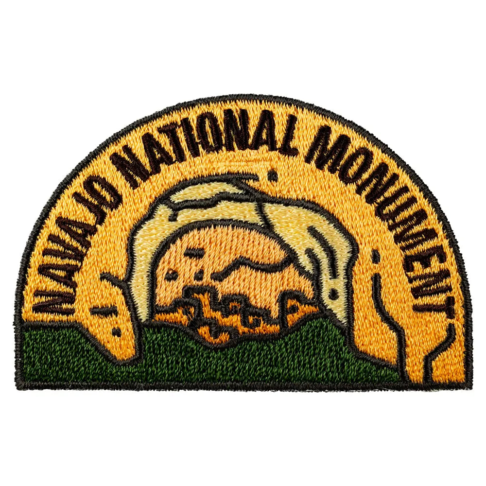 Embroidered patch of Navajo National Monument with an arch design on a white background