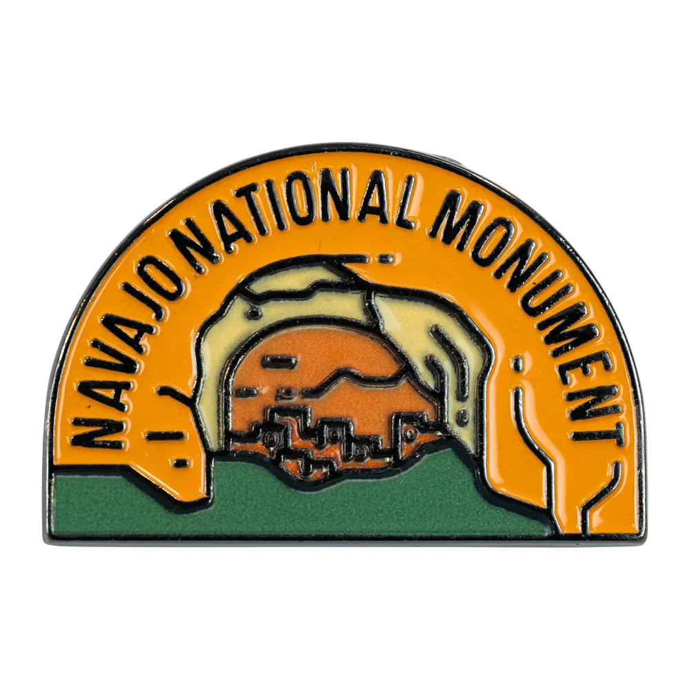 Pin with 'Navajo National Monument' text and emblem on a white background