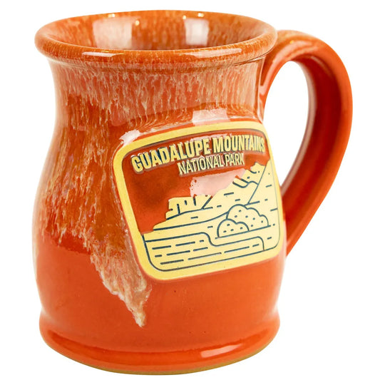 Orange mug with Guadalupe Mountains National Park design on a white background