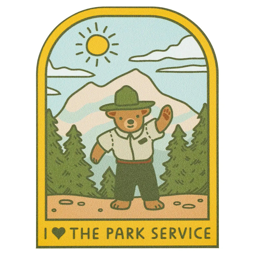 Illustration of a bear in a park ranger outfit with mountains and trees in the background, featuring the text 'I love the Park Service'.