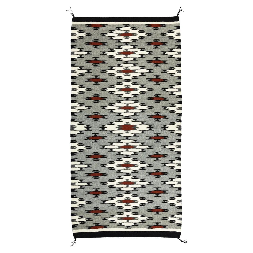 Navajo woven rug with geometric pattern on a white background