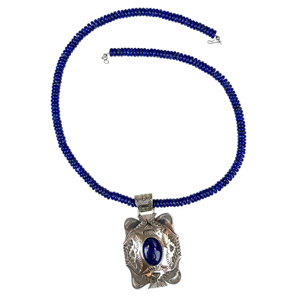 Blue beaded necklace with a silver pendant on a white background