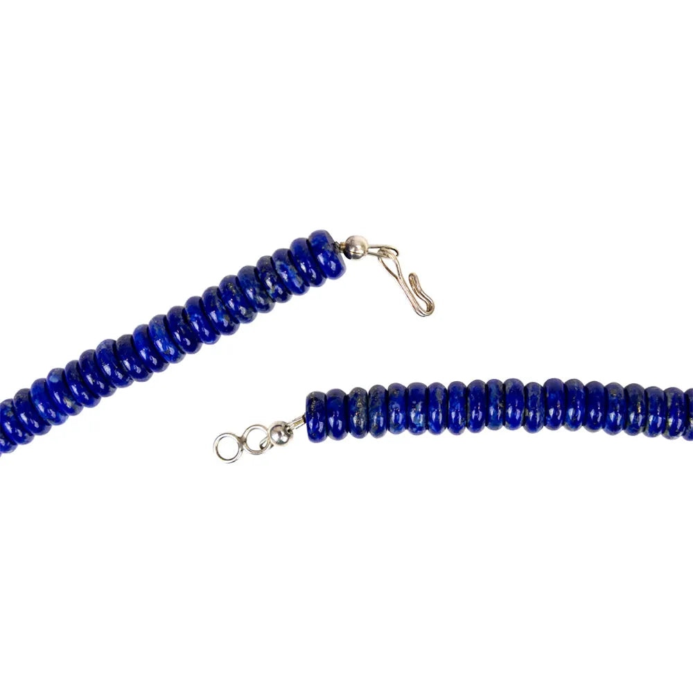 Blue beaded necklace with silver clasp on a white background