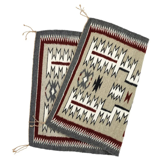 Folded view of storm pattern Navajo Rug by Nita Nez on a white background