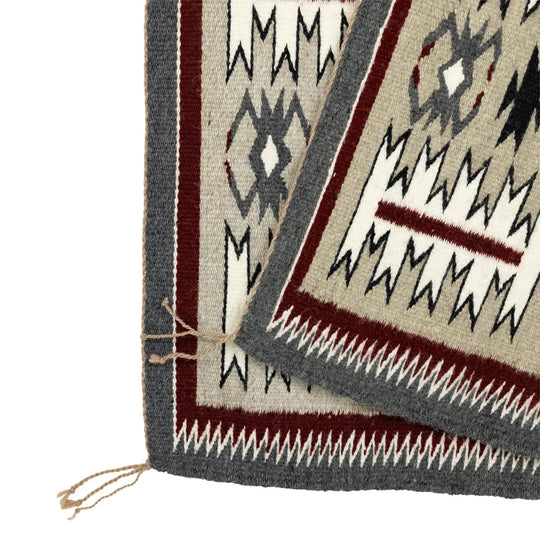 Close-up of a storm patterned Navajo rug on a white background