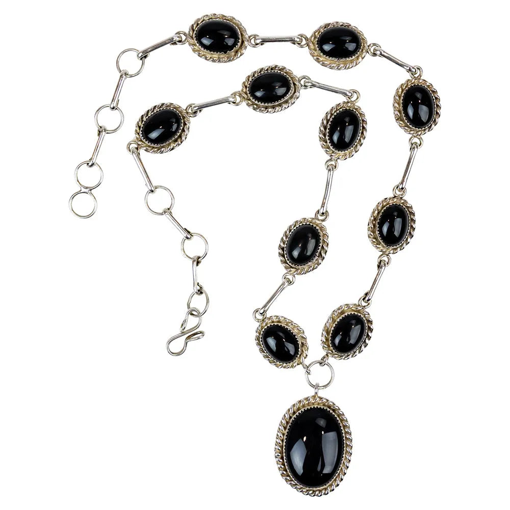Necklace with black gemstones and silver chain on a white background