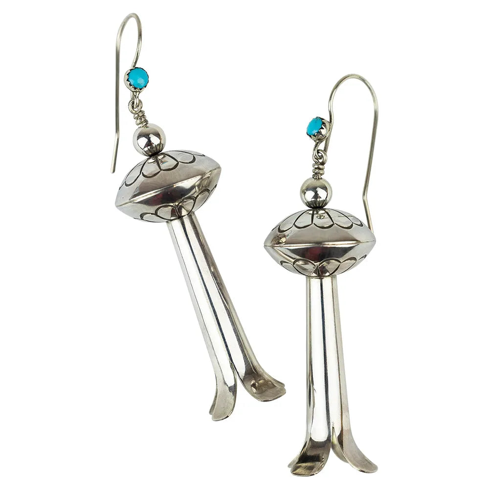 Sterling silver and turquoise earrings by Navajo silversmith Alton Joe on a white background.