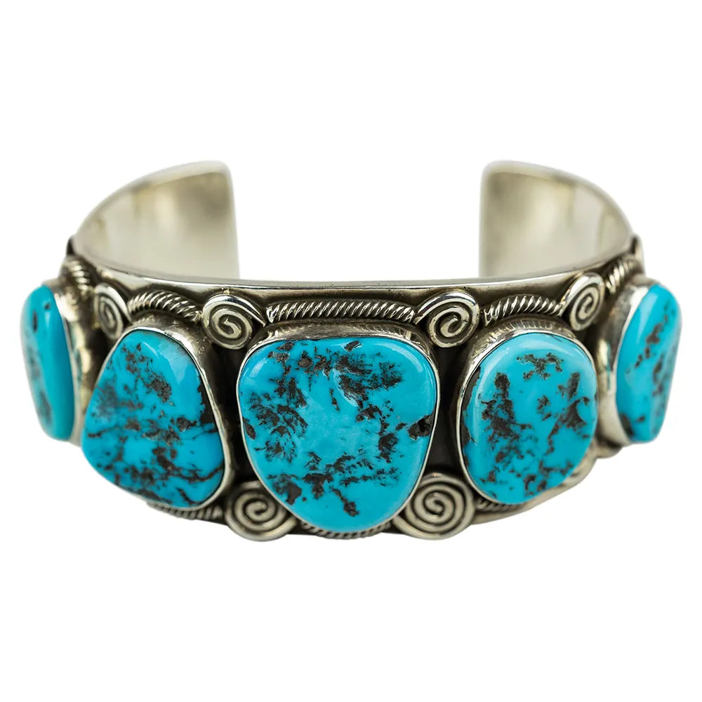 Navajo made silver, five-stone Turquoise cuff bracelet on white background