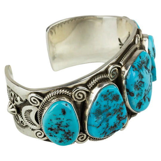 Navajo made silver, five-stone Turquoise cuff bracelet with interior view on white background