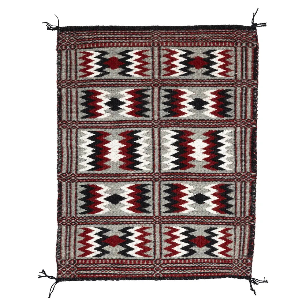Side one of Two-Faced Navajo Rug by Rosebelle Nez on white background.