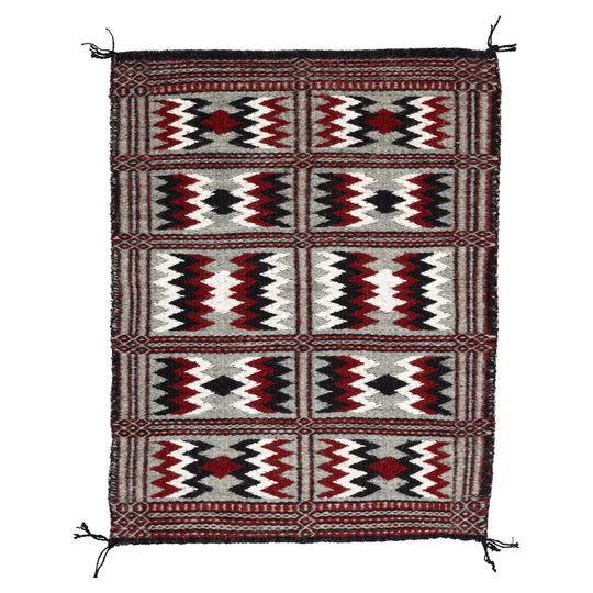 Side one of Two-Faced Navajo Rug by Rosebelle Nez on white background.