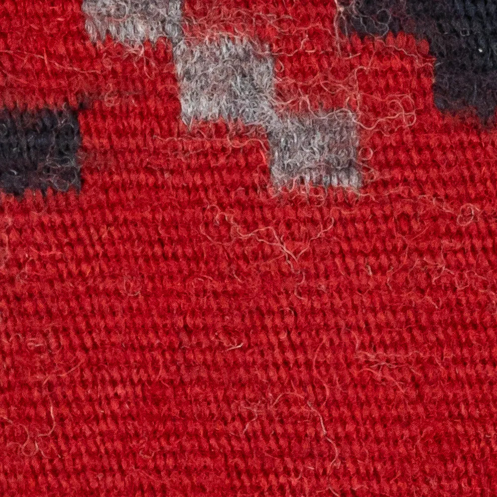 Close-up of red fabric with gray and black patches