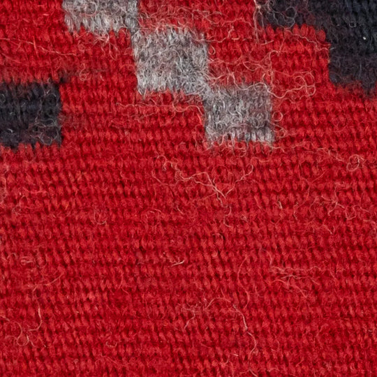 Close-up of red fabric with gray and black patches