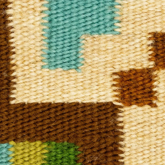 Close-up of a woven fabric with brown, beige, green, and blue patterns.