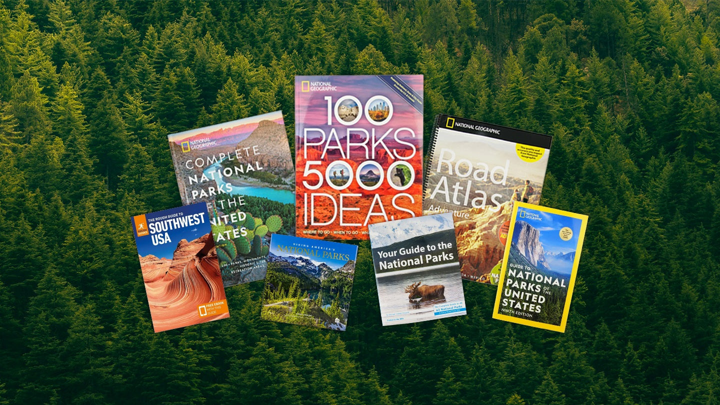 National park travel books superimposed over a green forest