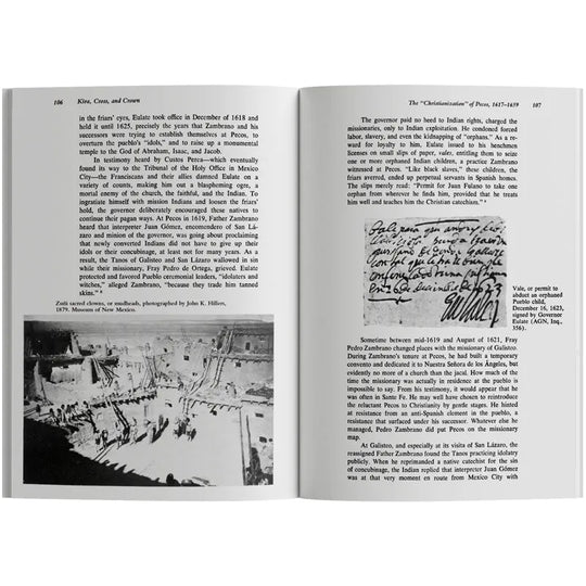 Open book with text and a black and white photograph on a white background