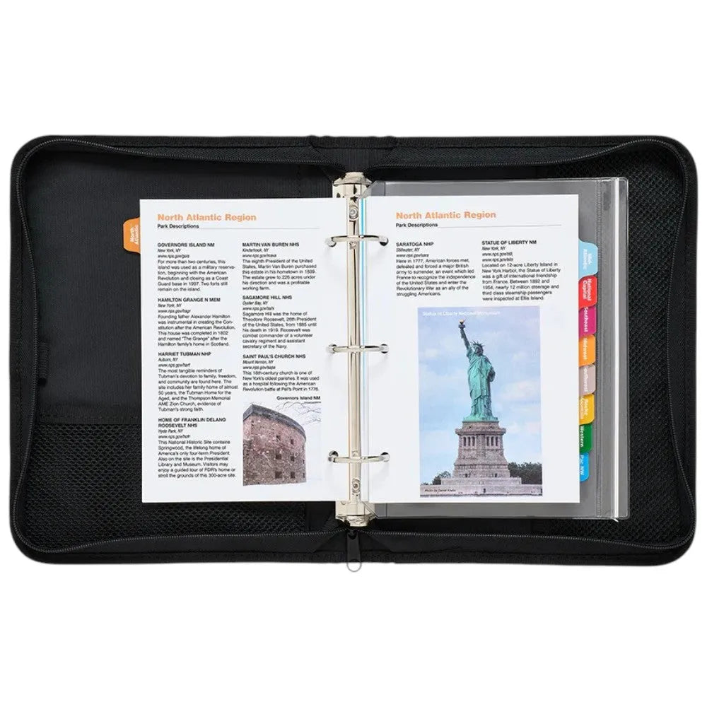 Black binder with open pages showing text and images, including a statue of liberty, on a white background.