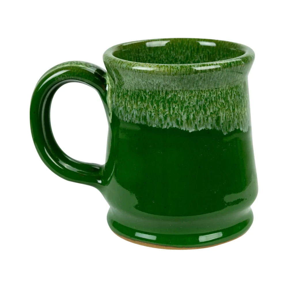 A green glazed ceramic mug with a thick handle and a textured, dripping glaze pattern near the rim, shown on a plain white background.