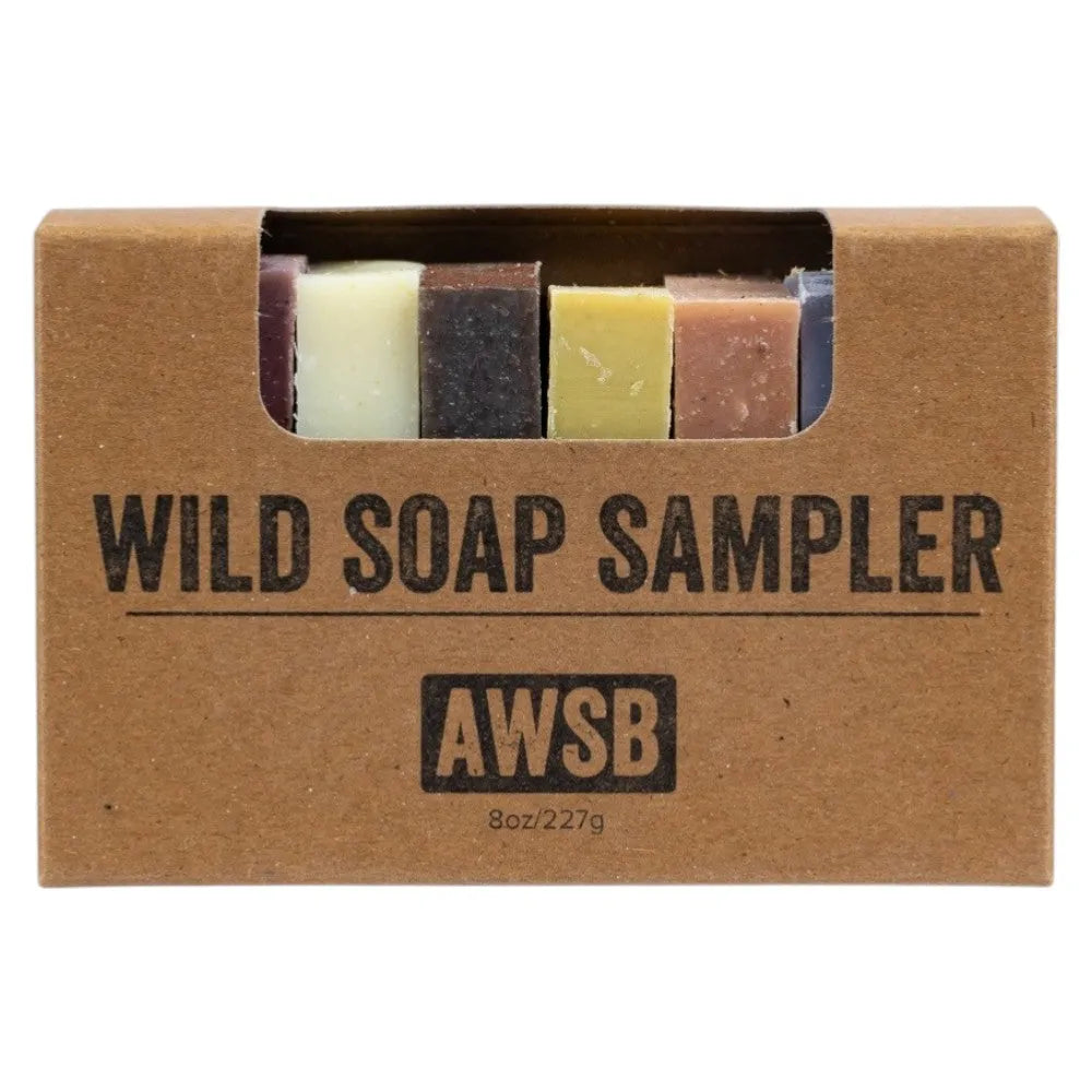Wild Soap Sampler with six of eight bars of soap showing in a cardboard box, featuring the label &