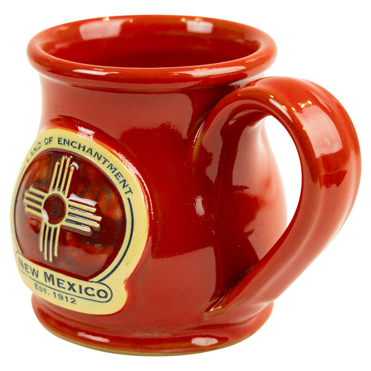 Red mug with New Mexico state emblem on a white background