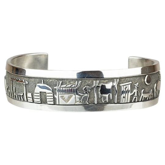 Sterling silver bracelet with embossed designs on a white background