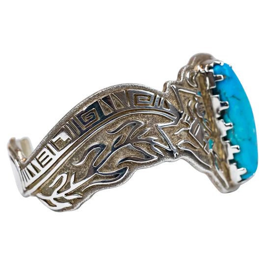 Silver bracelet with turquoise stone on a white background