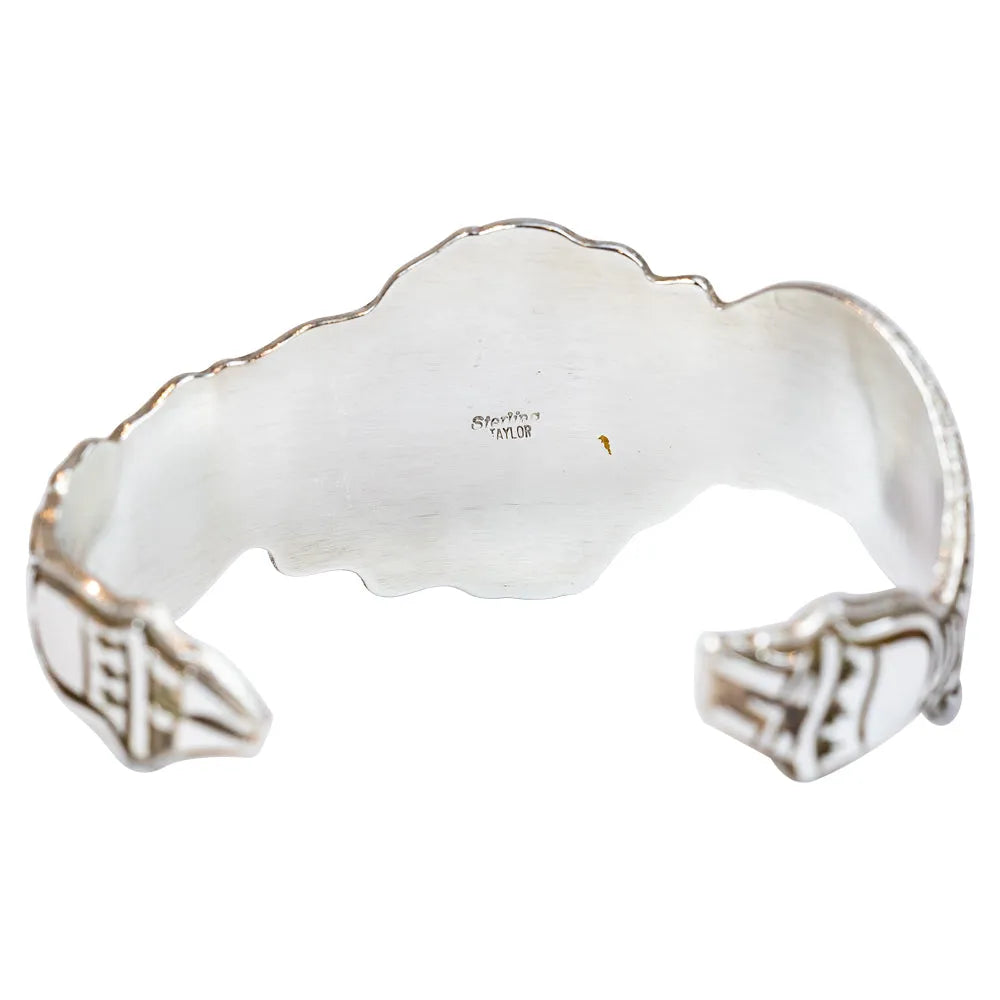 Silver bracelet with turquoise stone on a white background