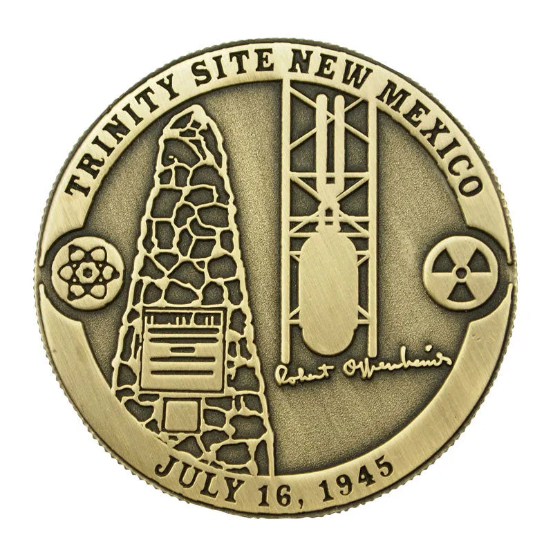 Bronze coin commemorating the Trinity Site in New Mexico with atomic bomb imagery and text.