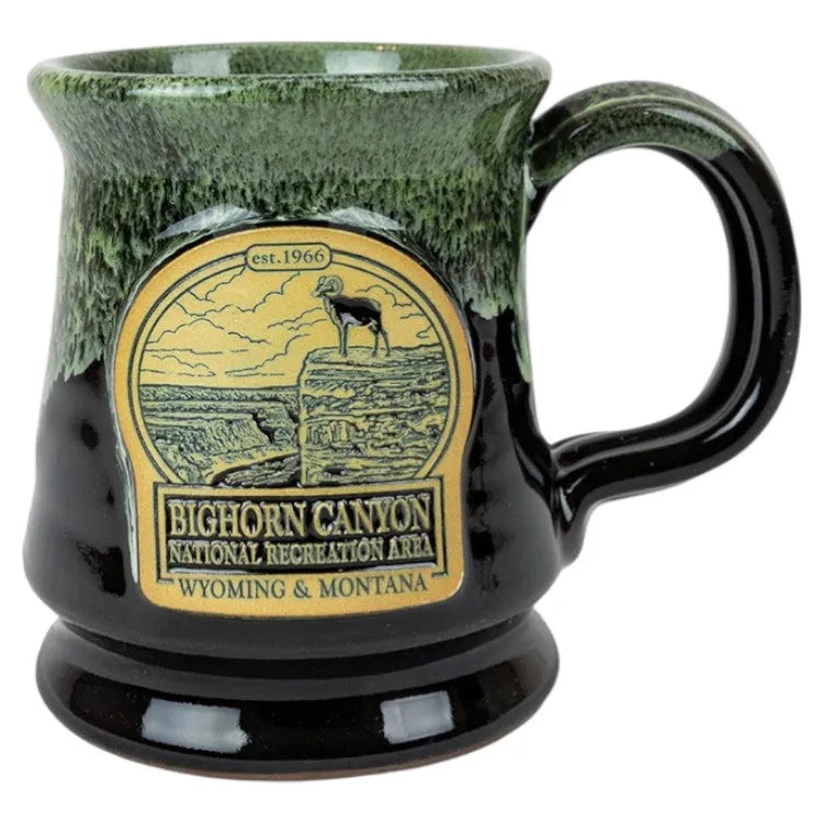 Green and black mug with Bighorn Canyon National Recreation Area logo