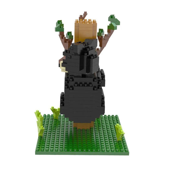 Mini block set of a black bear climbing a tree on a white background