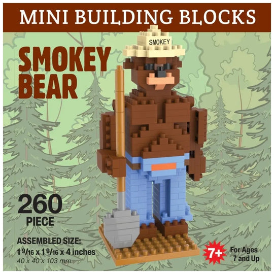Brick-built Smokey Bear figure with a shovel against a forest background, labeled &