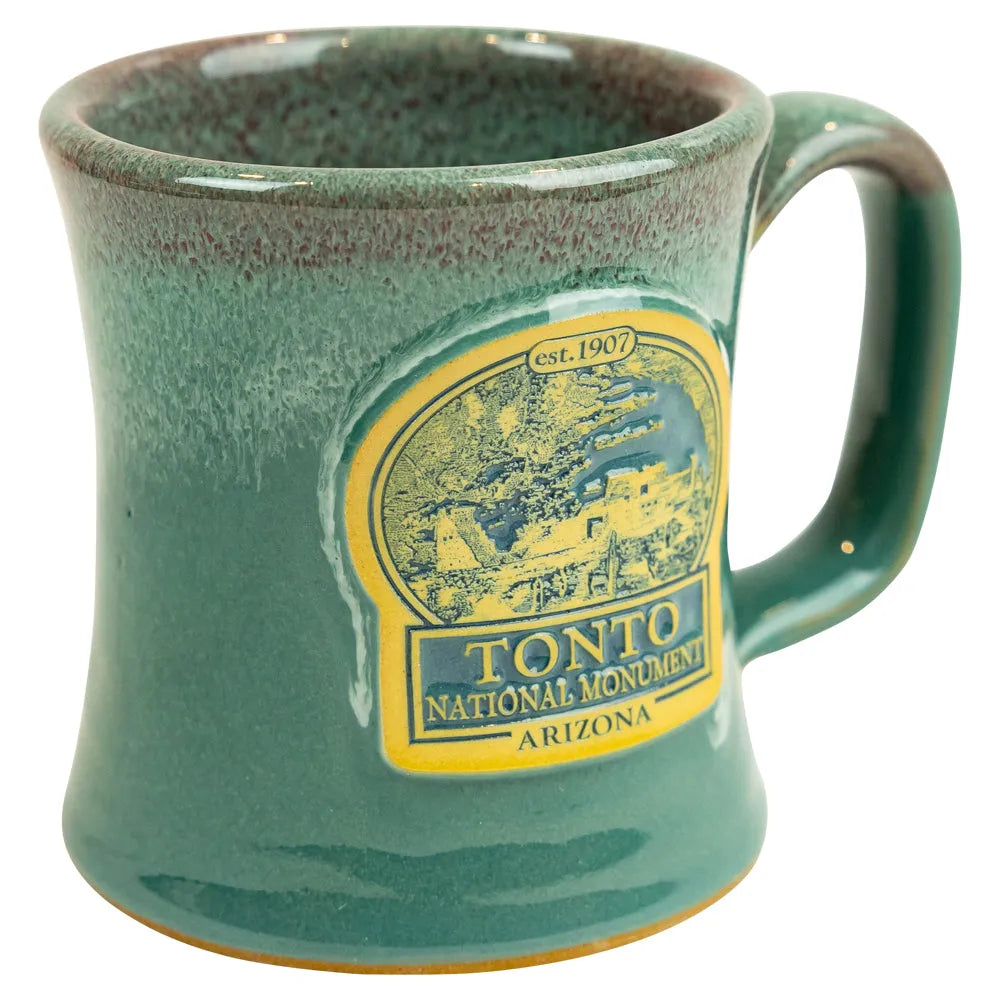 Green mug with Tonto National Monument logo on a white background