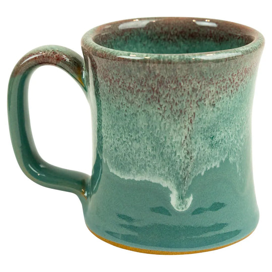 Teal ceramic mug with speckled pattern on a white background