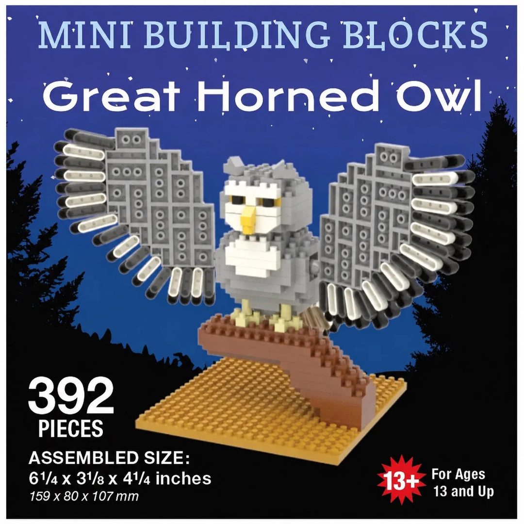 Product packaging graphic for a Mini Building Blocks set of a Great Horned Owl, showing the assembled gray and white owl on a brown perch over a blue starry night sky background with silhouettes of trees.