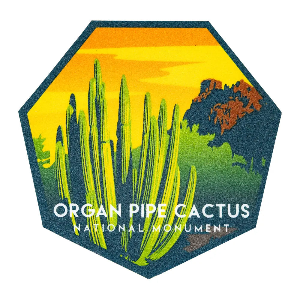 Logo of Organ Pipe Cactus National Monument against a sunset sky with cacti and desert landscape.