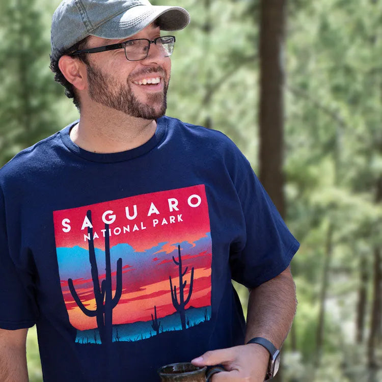Man wearing blue saguaro national park shirt while out in nature