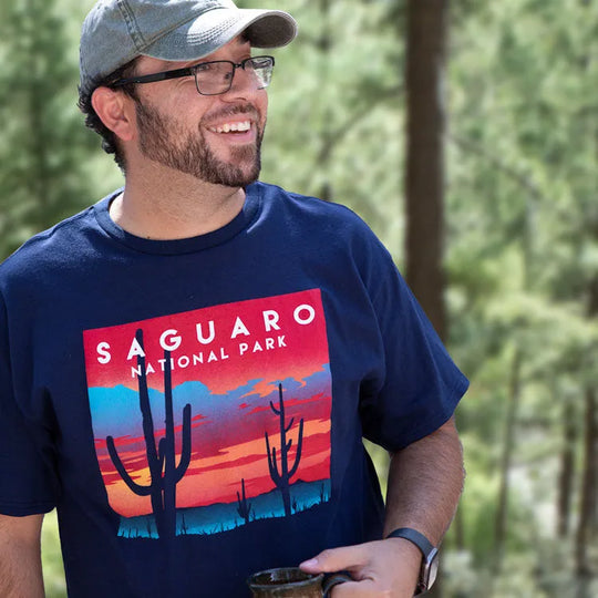 Man wearing blue saguaro national park shirt while out in nature