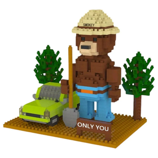 Brick-built Smokey the Bear figure with a green car and trees on a white background