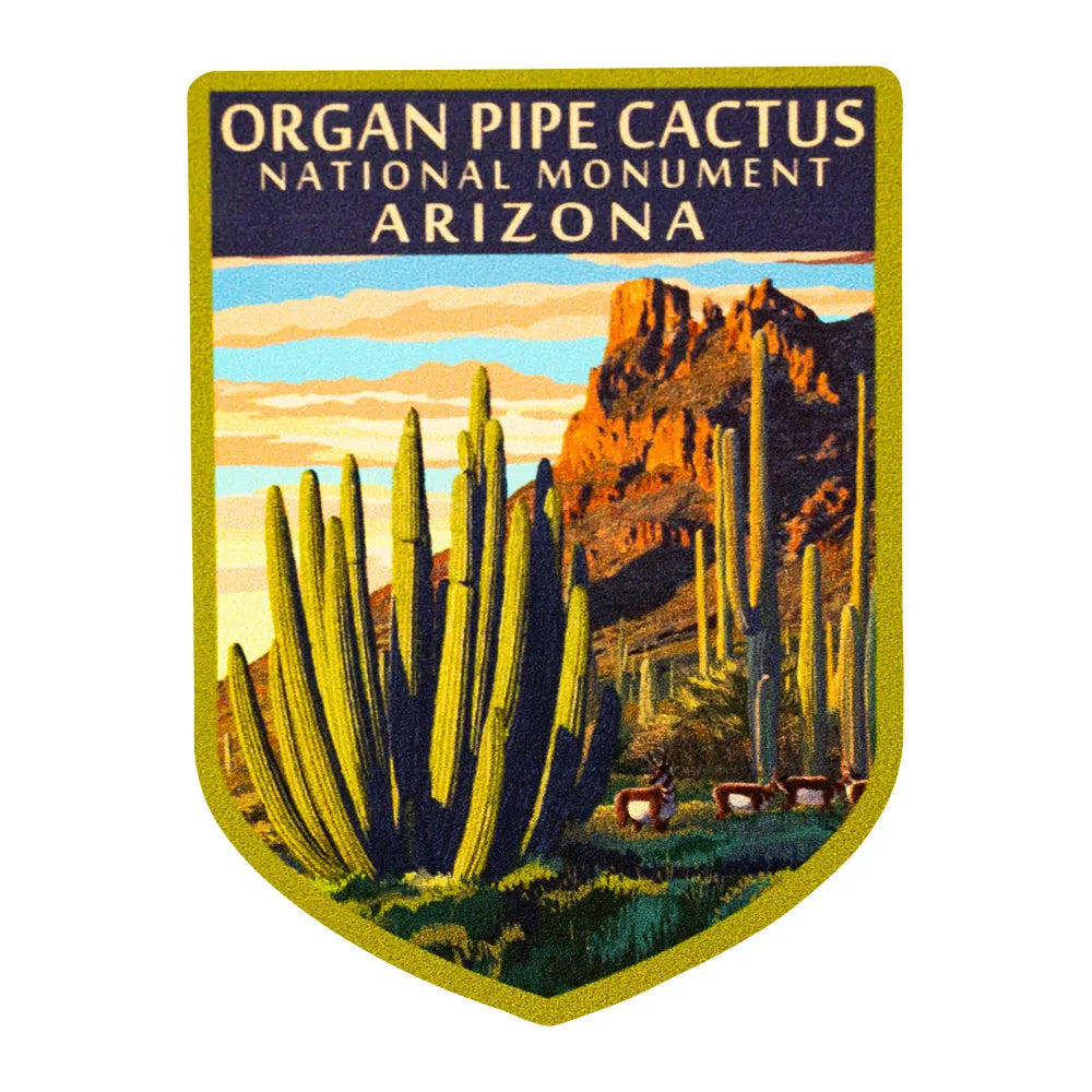 Emblem of Organ Pipe Cactus National Monument in Arizona with cacti and mountains.