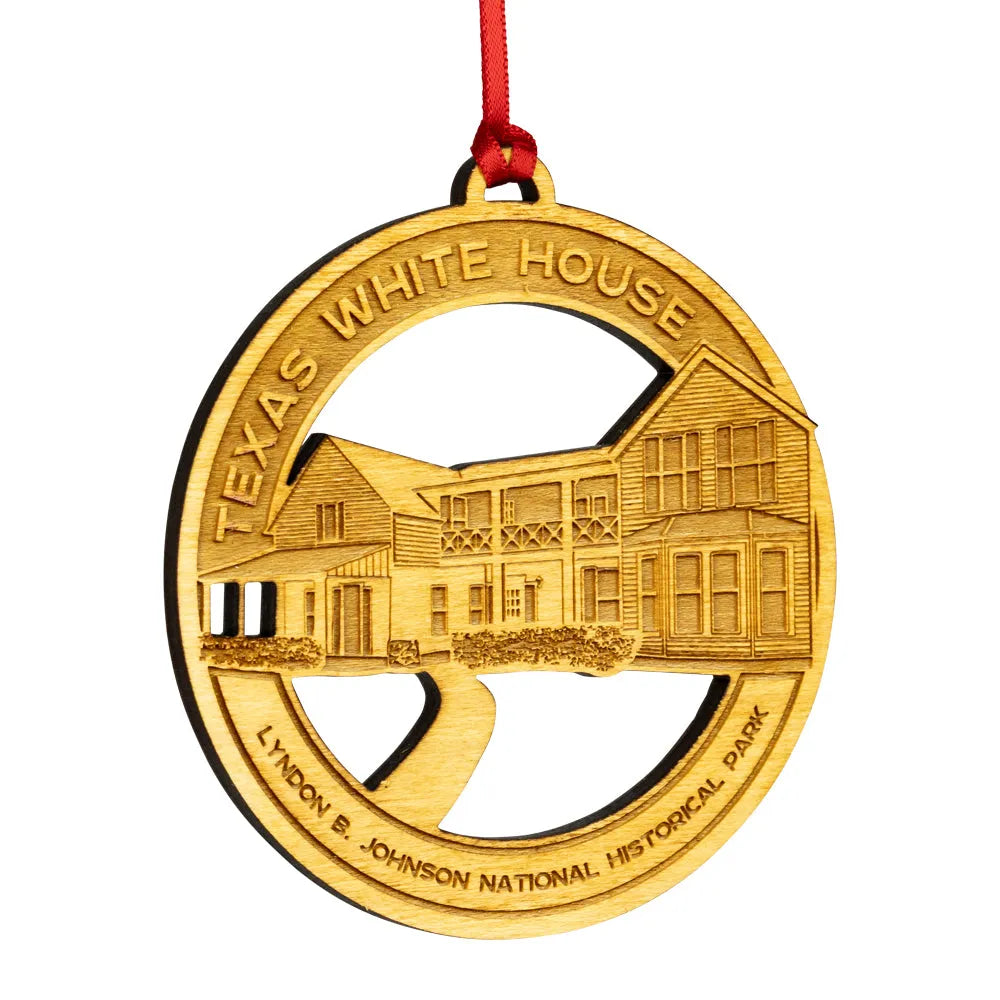 Etched wood ornament with Texas White House design on a white background