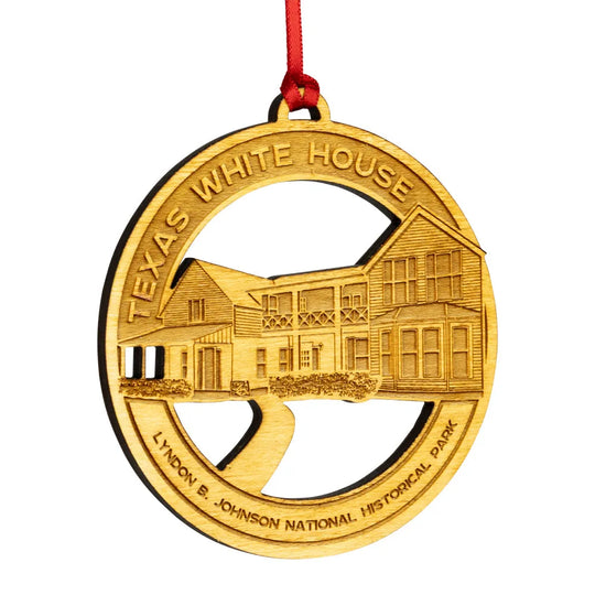 Etched wood ornament with Texas White House design on a white background