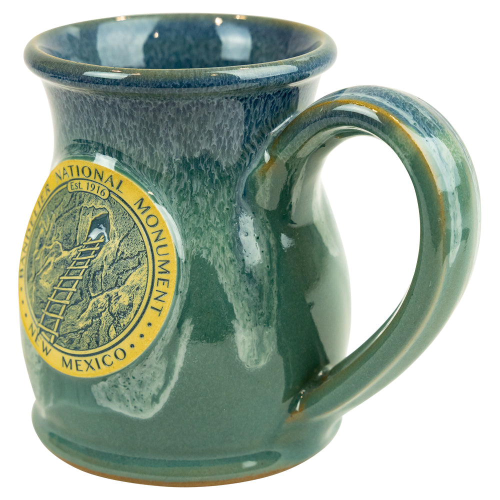 Green mug with a National Monument logo on a white background