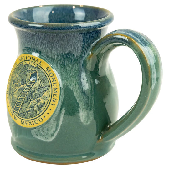 Green mug with a National Monument logo on a white background