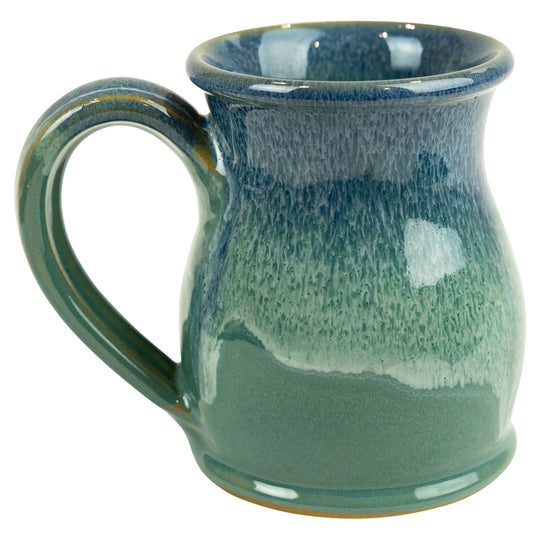 Green ceramic mug with speckled texture on a white background