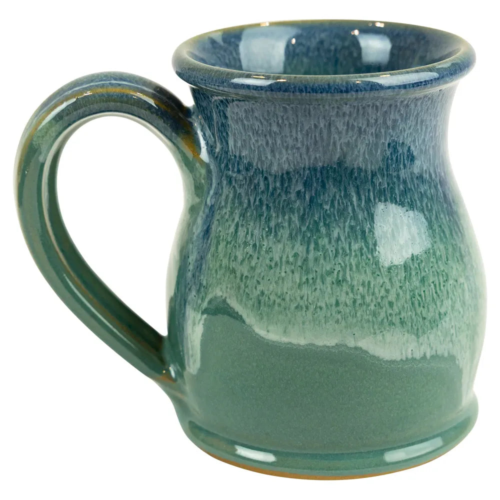 Green ceramic mug with speckled texture on a white background