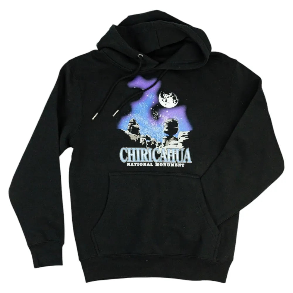 Black hoodie with Chiricahua National Monument graphic and one arm in the pocket on a white 