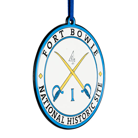 Circular metal ornament with 'Fort Bowle National Historic Site' text and crossed swords design on a white background.